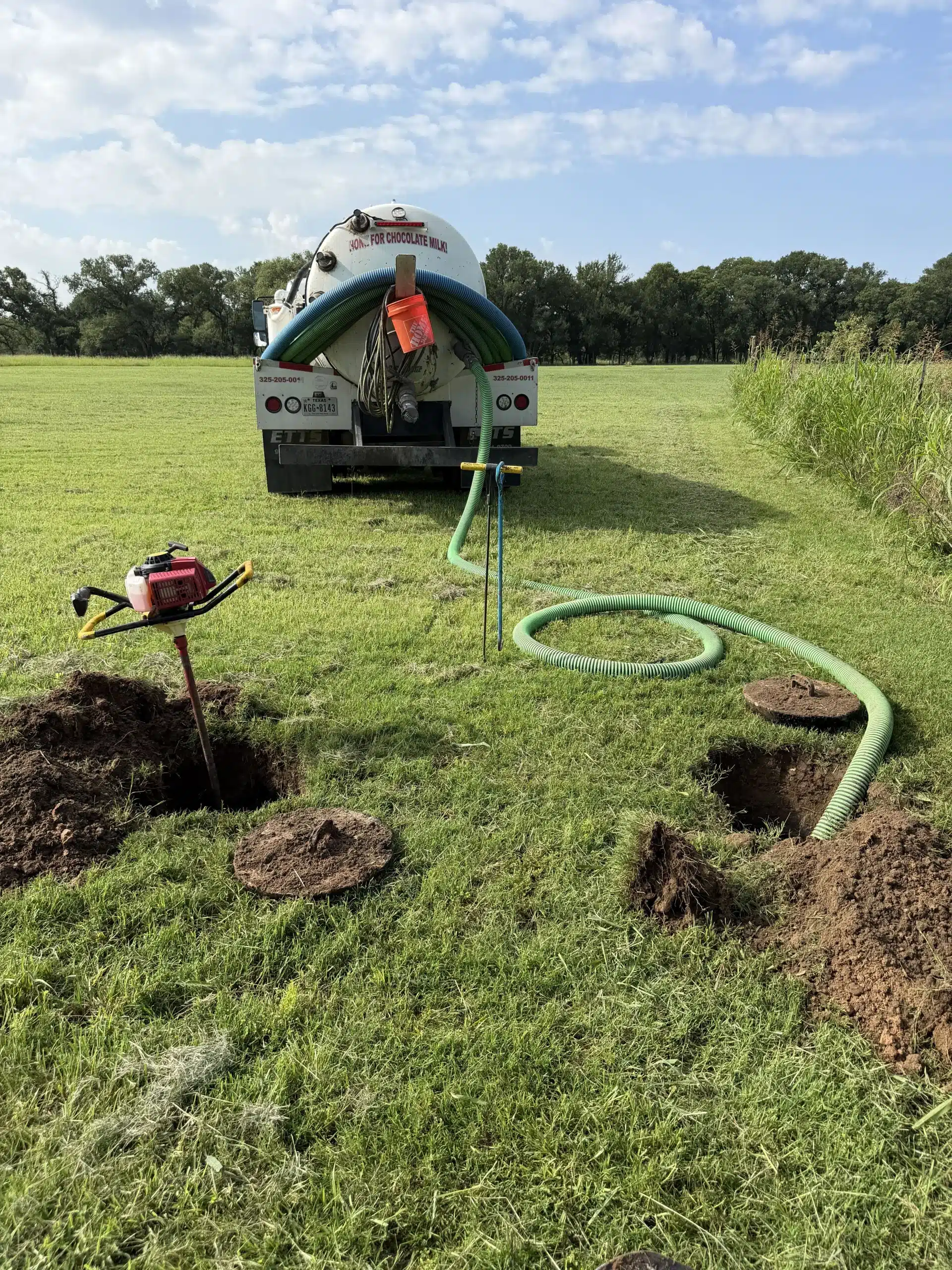 freshly serviced septic tank area with clean tank cover in well-maintained yard